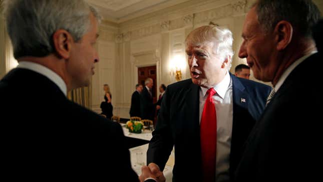 Jamie Dimon, left, shakes hands with Donald Trump, center