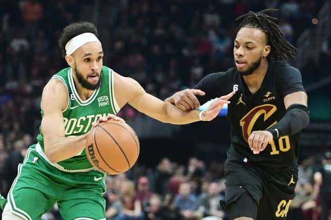 Mar 6, 2023; Cleveland, Ohio, USA; Boston Celtics guard Derrick White (9) drives to the basket against Cleveland Cavaliers guard Darius Garland (10) during the first half at Rocket Mortgage FieldHouse.