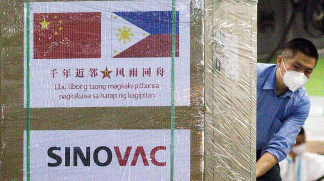 A worker unloads a box of Sinovac Biotech's CoronaVac vaccines against the coronavirus disease (COVID-19) from a Chinese military aircraft at Villamor Air Base in Pasay, Metro Manila, Philippines,