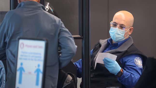 TSA agent screens passenger at airport