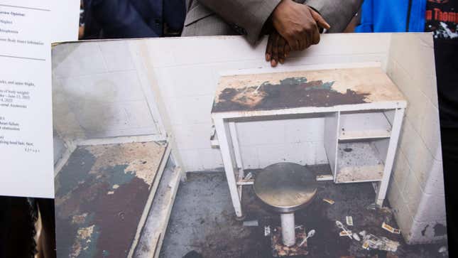 Attorney Michael Harper holds a photo of Lashawn Thompson’s cell in the Fulton County Jail at a press conference addressing the results of an independent autopsy determining the cause of death of Thompson on Monday, May 22, 2023, at the State Capital in Atlanta.