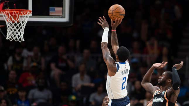 Dallas Mavericks guard Kyrie Irving shoots a three pointer against Atlanta Hawks forward AJ Griffin during the first half of an NBA basketball game, Sunday, April 2, 2023, in Atlanta.