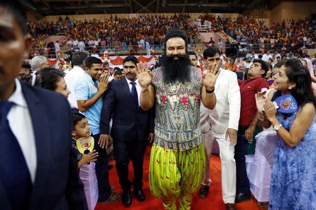 Gurmeet Ram Rahim Singh Ji Insan, centre, greets his followers ahead of the release of his movie “MSG, The Warrior Lion Heart,” in New Delhi.