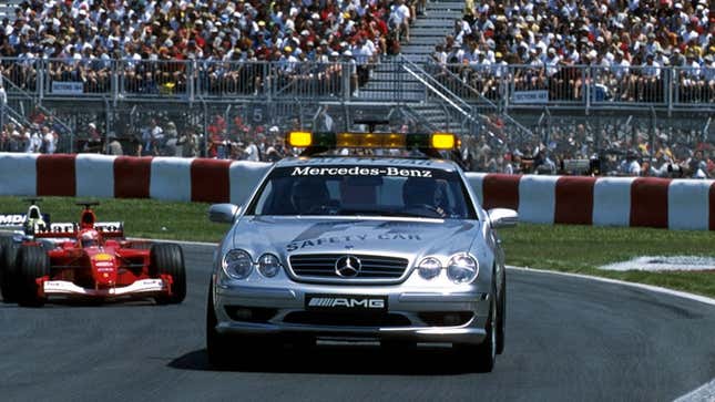 A silver Mercedes-Benz safety car leads a Ferrari f1 racer. 
