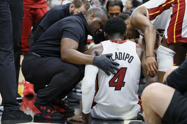 Apr 22, 2023; Miami, Florida, USA; Miami Heat guard Victor Oladipo (4) is checked on after an injury in the fourth quarter against the Milwaukee Bucks during game three of the 2023 NBA Playoffs at Kaseya Center.