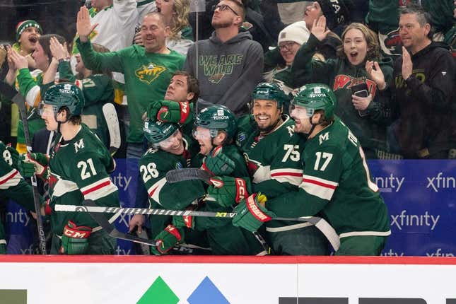Feb 26, 2023; Saint Paul, Minnesota, USA; Minnesota Wild right wing Ryan Reaves (75) left wing Marcus Foligno (17) and teammates celebrate a goal against the Columbus Blue Jackets in the third period at Xcel Energy Center.