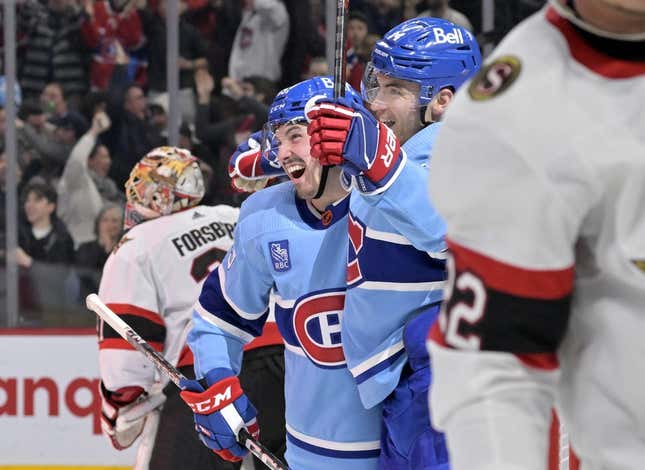 Jan 31, 2023; Montreal, Quebec, CAN; Montreal Canadiens forward Rafael Harvey-Pinard (49) celebrates with forward Nick Suzuki (14) after scoring a goal against Ottawa Senators goalie Anton Forsberg (left) during the third period at the Bell Centre.