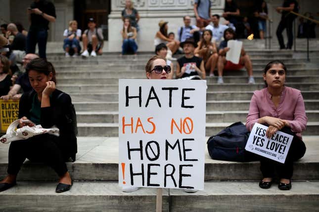 The protester holds a banner reading “Hate Has No Home Here” during a rally against U.S. President Donald J. Trump for threatening North Korea and Venezuela with attacking next to the Trump Tower in the Manhattan borough of New York, the United States, on August 14, 2017.