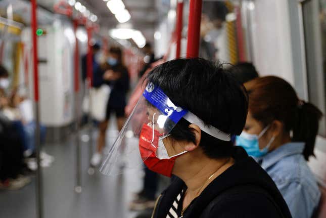 A woman wears a face mask and shield in an MTR train, amid the coronavirus disease (COVID-19) pandemic in Hong Kong, China, March 7, 2022.