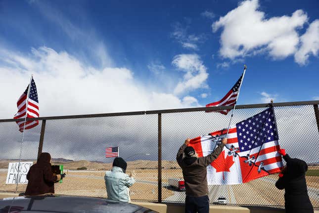 Supporters display a joint Canadian-American on an overpass as the ‘People’s Convoy’ passes on the way to Washington, DC to protest COVID-19 mandates on February 23, 2022 near Barstow, California. 