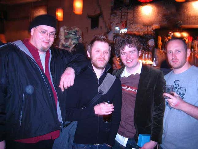 Mike Fahey of Kotaku stands next to Michael McWhertor and Luke Plunkett in a bar.