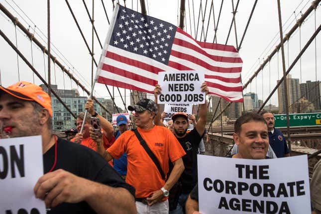 Hundreds of union members march across the Brooklyn Bridge in support of IBEW Local 3 (International Brotherhood of Electrical Workers)