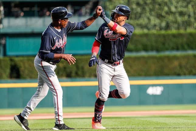 Atlanta Braves left fielder Eddie Rosario (8) celebrates with third base coach Ron Washington (37) after hitting a homer against the Detroit Tigers during the sixth inning of Game 2 of the doubleheader at Comerica Park in Detroit on Wednesday, June 14, 2023.