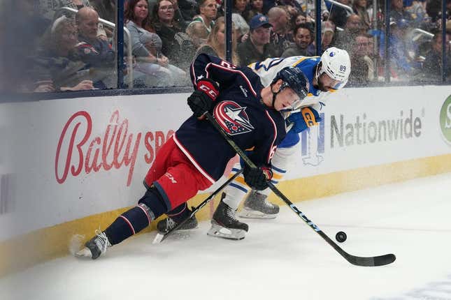 Apr 14, 2023; Columbus, Ohio, USA; Columbus Blue Jackets defenseman Samuel Knack (62) and Buffalo Sabres right wing Alex Tuch (89) battle for the puck during the first period at Nationwide Arena.