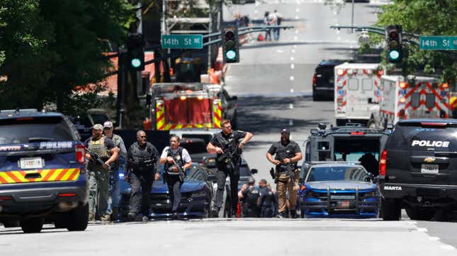 Law enforcement officers stage near the scene of an active shooter on Wednesday, May 3, 2023 in Atlanta.