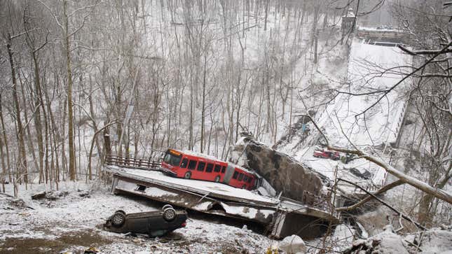 Vehicles including a Port Authority bus are left stranded after a bridge along Forbes Avenue collapsed on January 28, 2022 in Pittsburgh, Pennsylvania.  At least 10 people are believed to have been injured in the early morning collapse, hours before President Joe Biden's scheduled visit to promote his infrastructure plan.