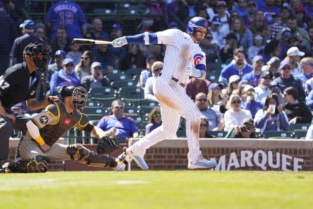 Apr 27, 2023; Chicago, Illinois, USA; Chicago Cubs left fielder Ian Happ (8) hits a RBI single against the San Diego Padres during the fifth inning at Wrigley Field.