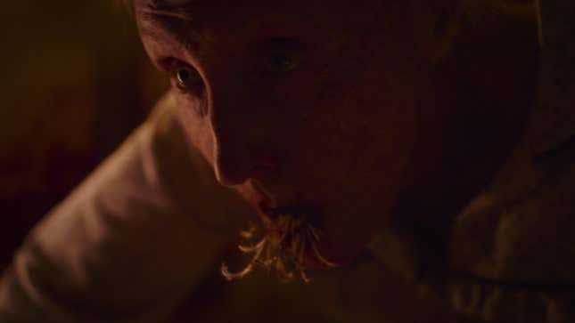 Fungal strands protrude from the mouth of an elderly woman in a scene from HBO's The Last of Us.