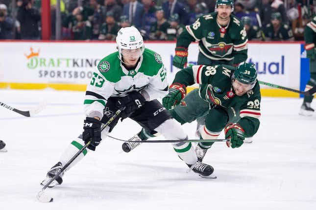 Apr 23, 2023; Saint Paul, Minnesota, USA; Dallas Stars center Wyatt Johnston (53) skates with the puck against the Minnesota Wild right wing Ryan Hartman (38) in the first period in game four of the first round of the 2023 Stanley Cup Playoffs at Xcel Energy Center.