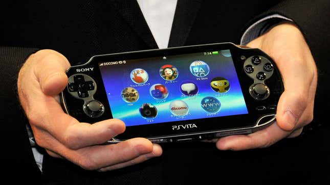 A PS Vita is held at the 2012 launch event. 