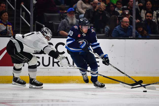 Mar 25, 2023; Los Angeles, California, USA; Winnipeg Jets left wing Pierre-Luc Dubois (80) moves the puck against Los Angeles Kings center Anze Kopitar (11) during the third period at Crypto.com Arena.
