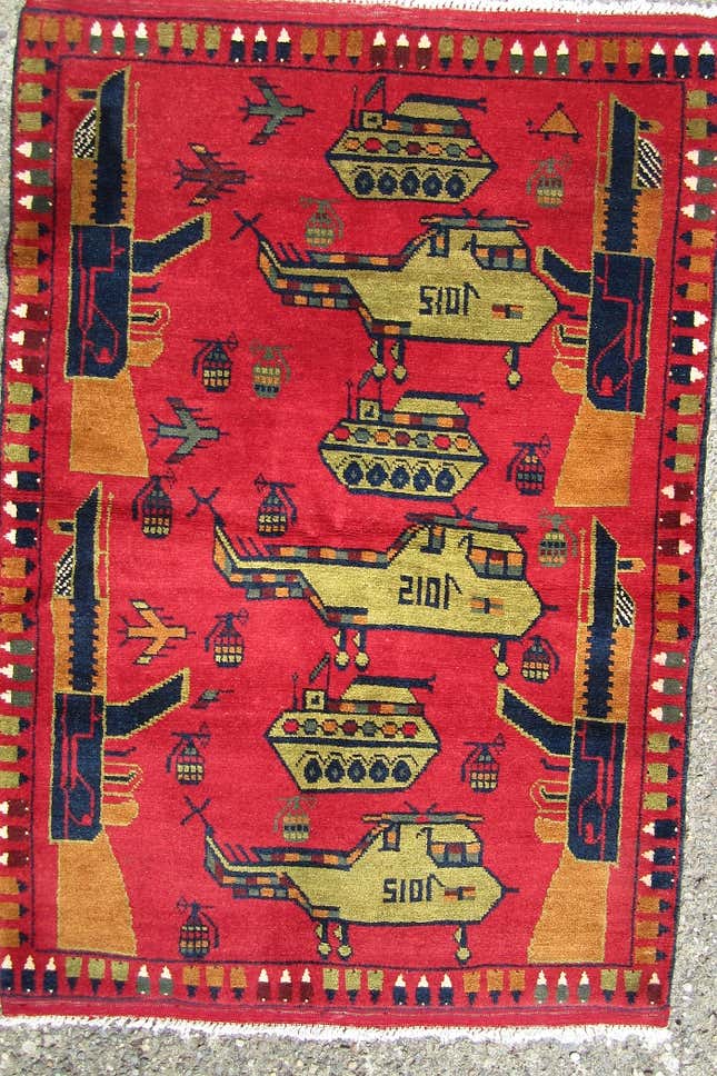 Image for article titled Afghan carpet weavers are putting drones on their rugs