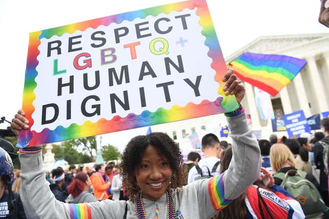 Demonstrators in favor of LGBT rights rally outside the US Supreme Court in Washington, DC, on October 8, 2019, as the Court holds oral arguments in three cases dealing with workplace discrimination based on sexual orientation. 