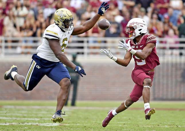 Oct 29, 2022; Tallahassee, Florida, USA; Florida State Seminoles running back Lawrance Toafili (9) catches a pass for a touchdown past Georgia Tech Yellow Jackets defensive lineman Keion White (6) during the game at Doak S. Campbell Stadium.