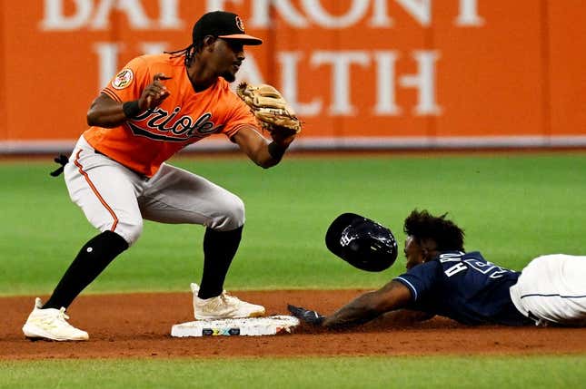 Jul 22, 2023; St. Petersburg, Florida, USA; Tampa Bay Rays left fielder Randy Arozarena (56) lies as Baltimore Orioles short stop Jorge Mateo (3) attempts to place the tag in the eighth inning at Tropicana Field.