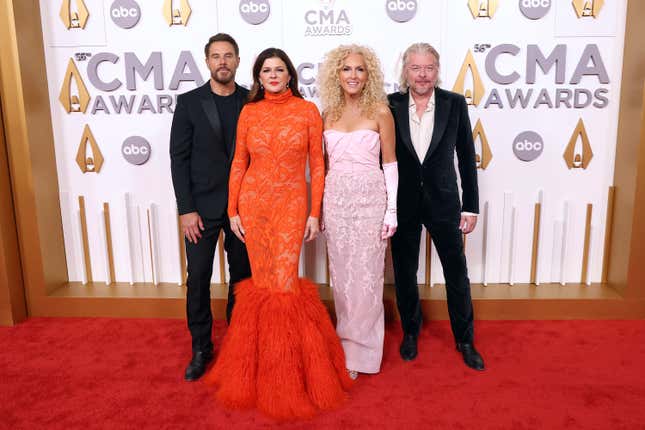 Image for article titled 2022 CMAs Red Carpet: Katy Perry Wears Stupid Denim Jumpsuit With Giant Bow, Etc.