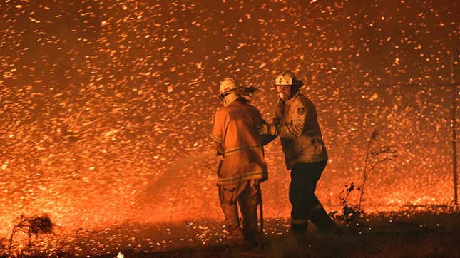 Dos bomberos trabajan para sofocar uno de los incendios de Australia de 2020