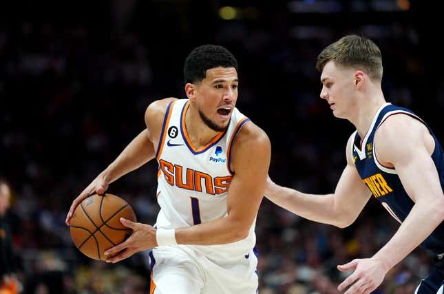 May 1, 2023; Denver, Colorado, USA; Phoenix Suns guard Devin Booker (1) and Denver Nuggets guard Christian Braun (0)  in the first half during game two of the 2023 NBA playoffs at Ball Arena.