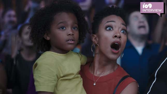 Sonequa Martin-Green looks shocked while holding Harper Leigh-Alexander in her arms in Space Jam: A New Legacy.