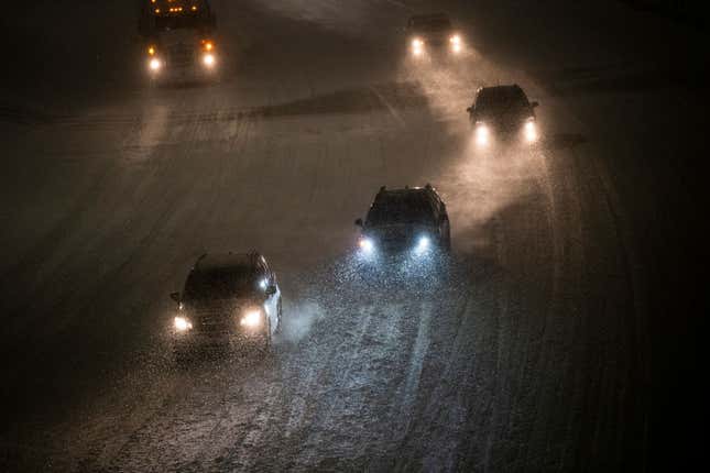 Cars drive through snow along highway 94 on February 23, 2023 in Minneapolis, Minnesota. The winter storm has caused major travel disruption across the country. 