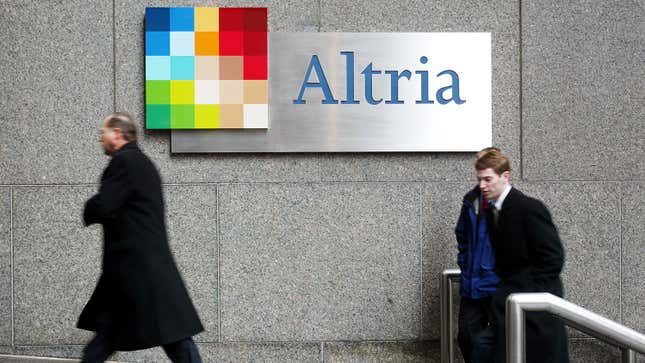 Businessmen enter the former Philip Morris offices which became Altria in 2003 in New York City.