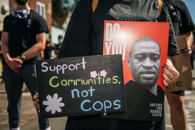 A person holds a sign of George Floyd during a demonstration on August 17, 2020 in Minneapolis, Minnesota. 
