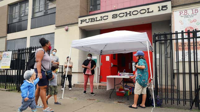 City council members, parents, and students participate in an outdoor learning demonstration in front of a public school in the Red Hook, Brooklyn area of New York on September 2, 2020. 