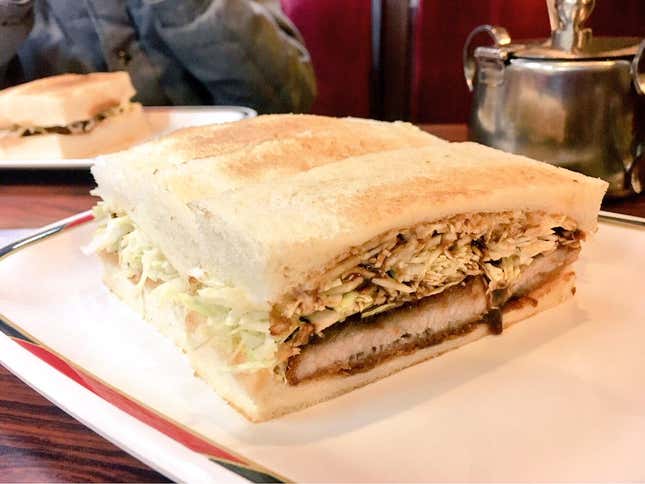 Miso katsu sando with chopped cabbage served on toasted bread.