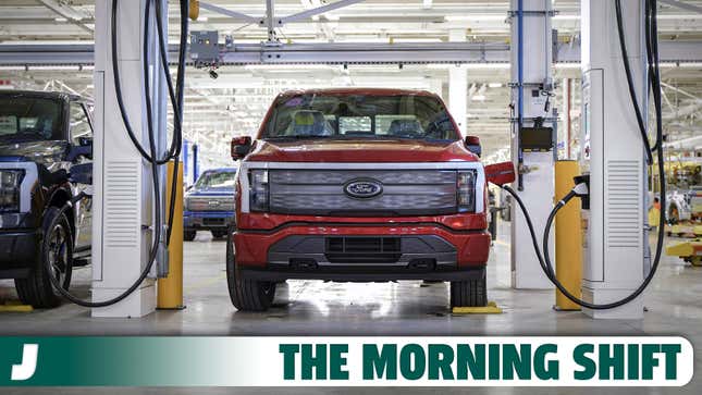 Front view of a red Ford F-150 Lightning as it charges in one of Ford's manufacturing facilities.