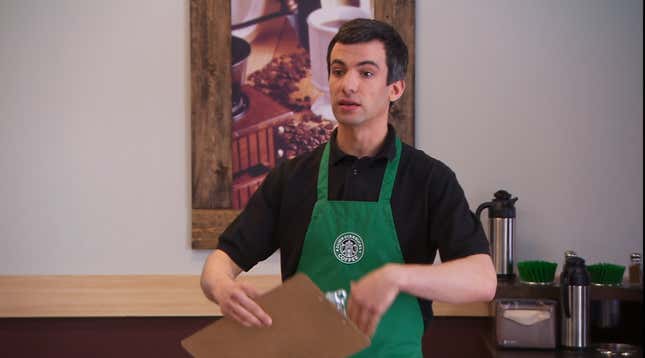 Nathan Fielder wearing a Dumb Starbucks apron