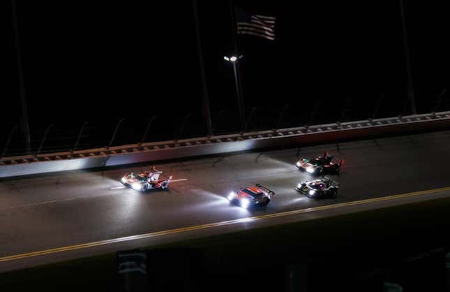 Porsche Penske Motorsport’s No. 6 and 7 on the back straight at Daytona under the lights, while both were still running.