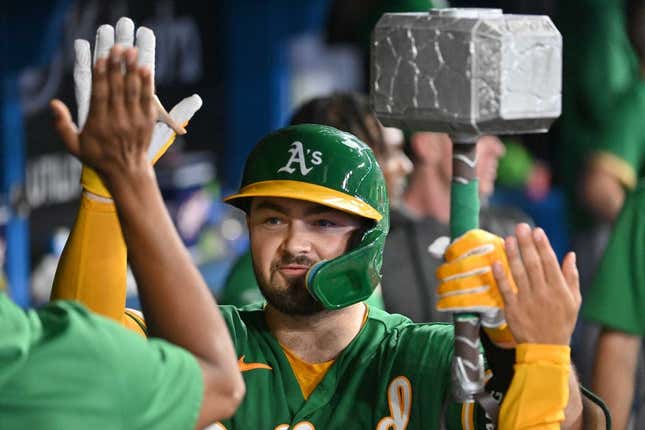 Jun 23, 2023; Toronto, Ontario, CAN; Oakland Athletics catcher Shea Langeliers (23) celebrates in the dugout with the team home run hammer after hitting a solo home run against the Toronto Blue Jays in the ninth inning at Rogers Centre.