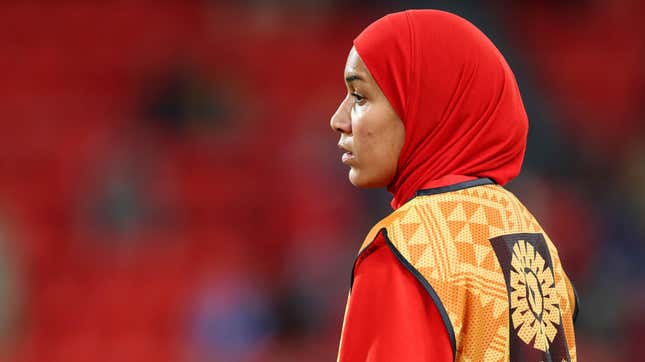 Nouhaila Benzina stares out at a blurry field during a game.