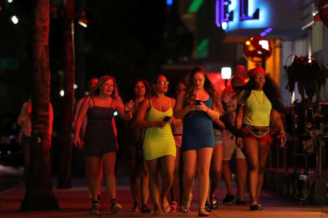 University students walk along a street of Miami Beach during Spring Break after local authorities closed restaurants, bars, gyms, movie theaters and other similar businesses and rolled out a midnight curfew along South Beach’s busiest strips for precaution due to coronavirus disease (COVID-19) spread, in Miami Beach, Florida, U.S., March 18, 2020. REUTERS/Carlos Barria – RC2QMF98U37N