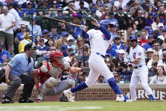 May 28, 2023; Chicago, Illinois, USA; Chicago Cubs center fielder Mike Tauchman (40) hits a single against the Cincinnati Reds during the fourth inning at Wrigley Field.