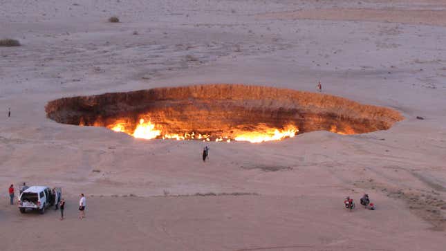A jeep and visitors seen at the Gateway to Hell, a huge burning gas crater in the heart of Turkmenistan's Karakum Desert.