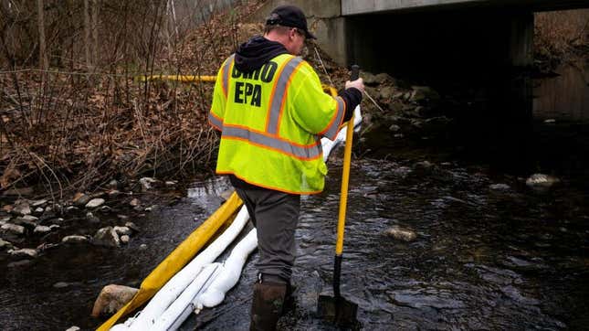 Ron Fodo, Ohio EPA Emergency Response, looks for signs of fish in Leslie Run creek to check for chemicals that have settled at the bottom following the train derailment  in East Palestine, Ohio.