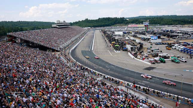 Cars negotiate turn one during the NASCAR Cup Series Ambetter 301 on July 17, 2022, at New Hampshire Motor Speedway in Loudon. New Hampshire.