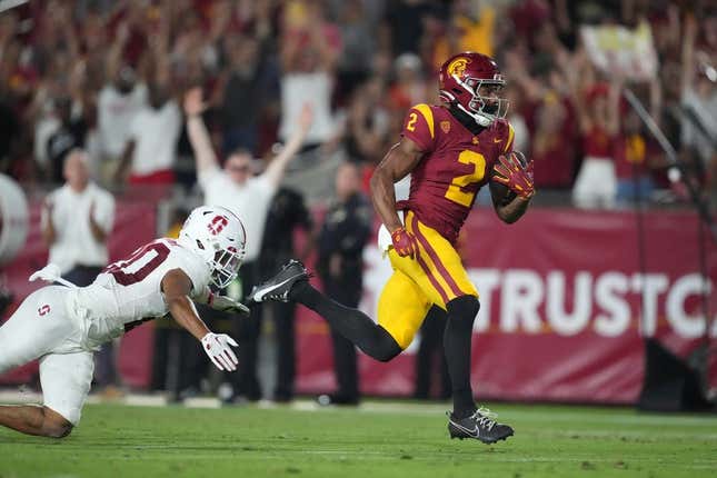 Sep 9, 2023; Los Angeles, California, USA; Southern California Trojans wide receiver Brenden Rice (2) scores on a 75-yard touchdown reception against Stanford Cardinal cornerback Jaden Slocum (20) in the first half at United Airlines Field at Los Angeles Memorial Coliseum.