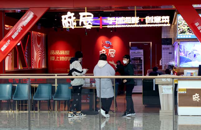 Customers enter a restaurant as Beijing no longer requires people to  show their negative nucleic acid testing results before entering public  places on December 6, 2022 in Beijing, China. 